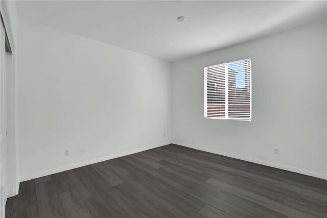 unfurnished room featuring dark hardwood / wood-style flooring