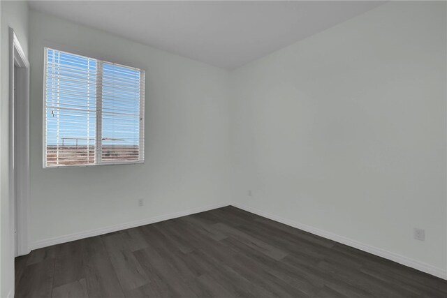 unfurnished room with dark hardwood / wood-style floors