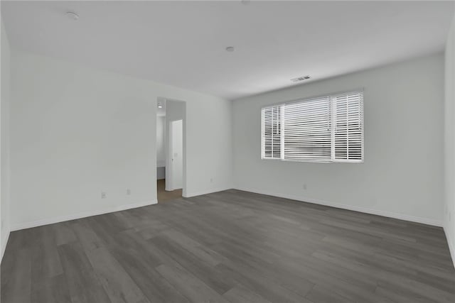 empty room featuring dark wood-type flooring