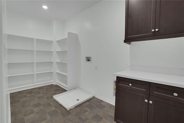 laundry area with hookup for a washing machine and cabinets