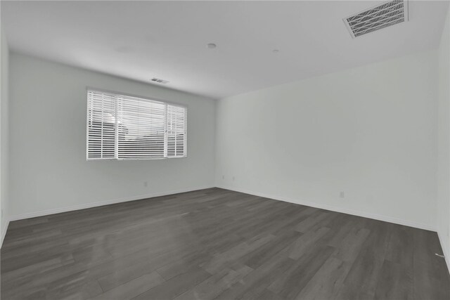 spare room with dark hardwood / wood-style flooring