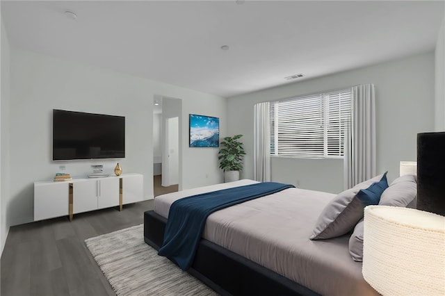 bedroom with dark hardwood / wood-style flooring