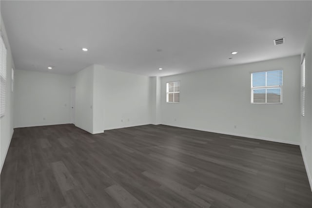 unfurnished room featuring dark hardwood / wood-style floors and a wealth of natural light