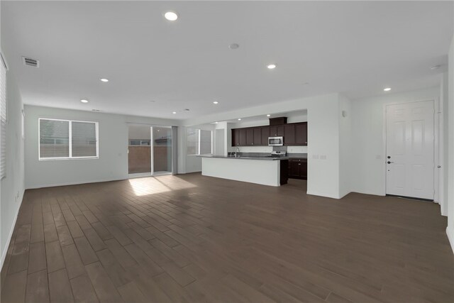 unfurnished living room featuring dark hardwood / wood-style floors