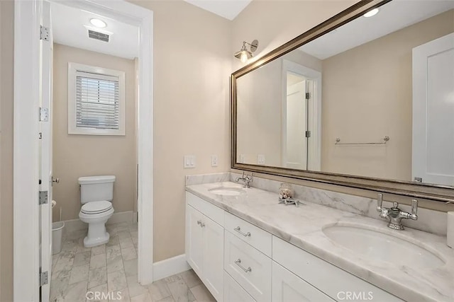 bathroom with vanity and toilet