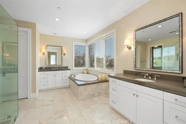 bathroom featuring plus walk in shower and vanity