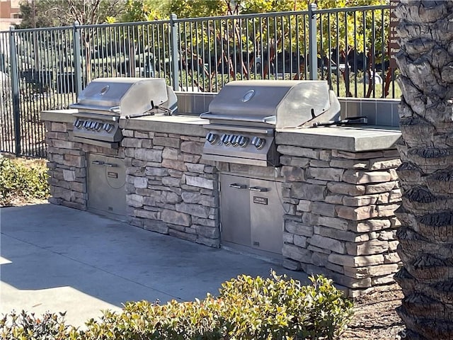 24445 Paxton Ln, Lake Elsinore, CA 92532 - view of patio featuring fence, area for grilling, and an outdoor kitchen