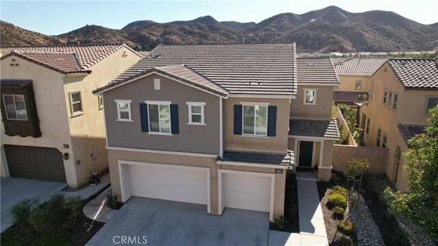 view of front of property with a garage and a mountain view