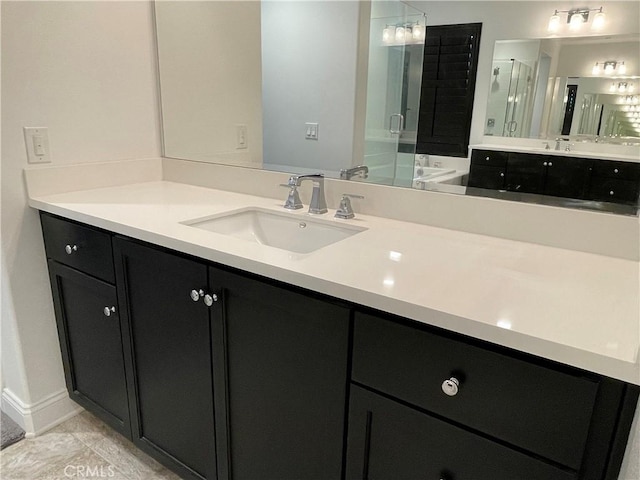 bathroom with vanity, a shower with shower door, and tile patterned floors