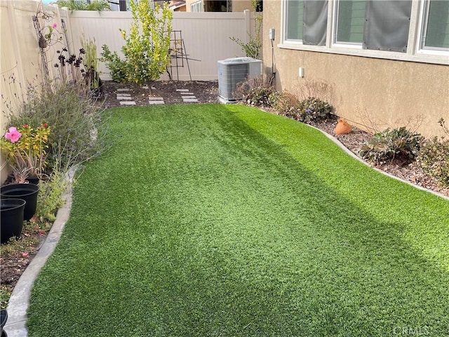 view of yard featuring central air condition unit