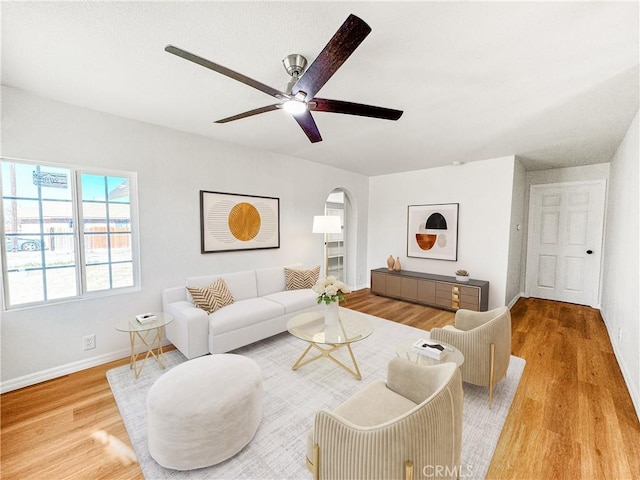 living room featuring hardwood / wood-style floors and ceiling fan