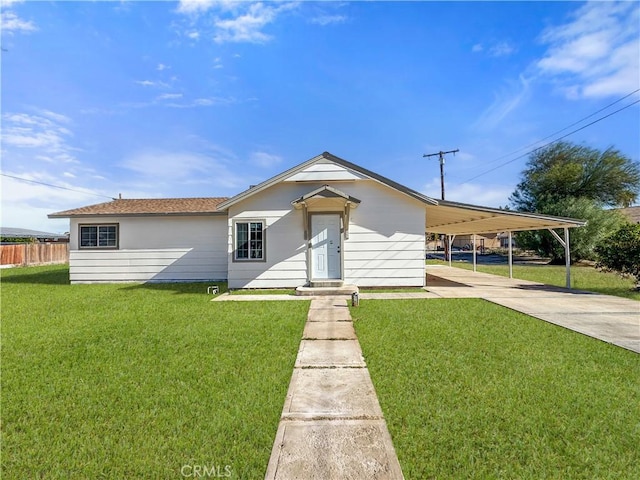 view of front of property with a carport and a front lawn