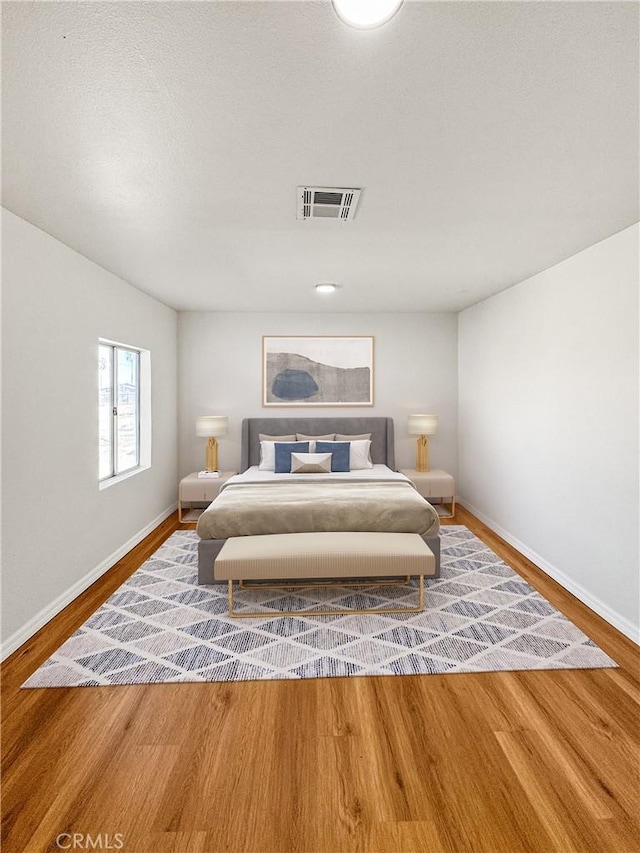 bedroom with hardwood / wood-style flooring