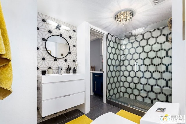 bathroom with vanity, a notable chandelier, and walk in shower