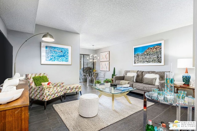 living room featuring a textured ceiling and a notable chandelier