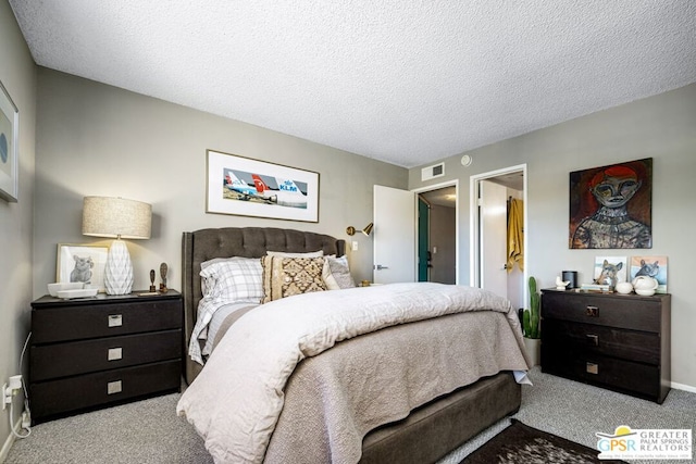 carpeted bedroom featuring a textured ceiling