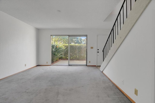 unfurnished living room with light carpet