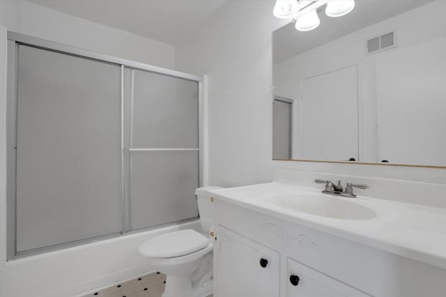 full bathroom with toilet, vanity, and shower / bath combination with glass door