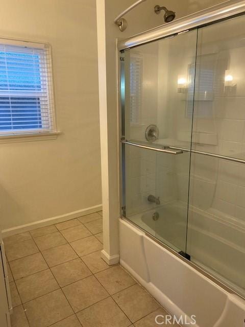 bathroom with tile patterned flooring and shower / bath combination with glass door