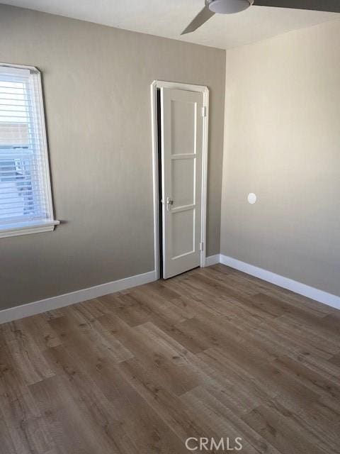 spare room featuring dark hardwood / wood-style floors and ceiling fan