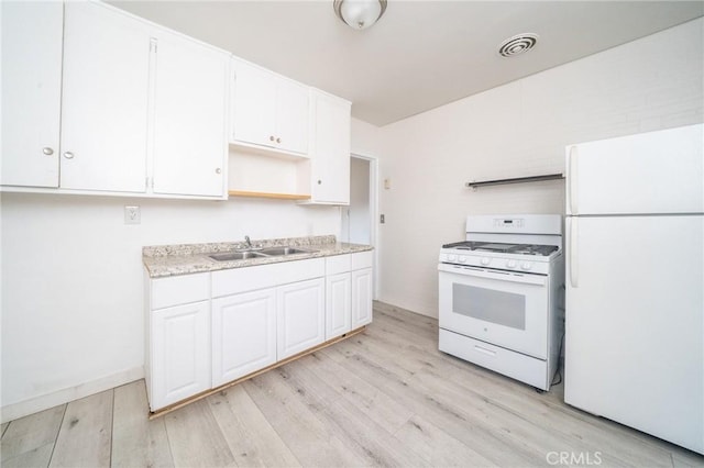 kitchen featuring white appliances, light hardwood / wood-style flooring, white cabinetry, and sink