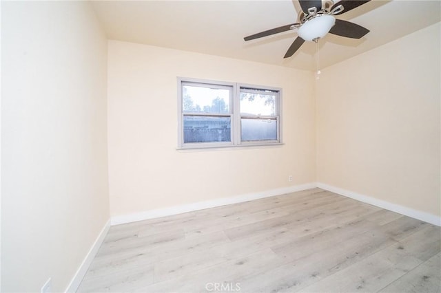 spare room with ceiling fan and light wood-type flooring