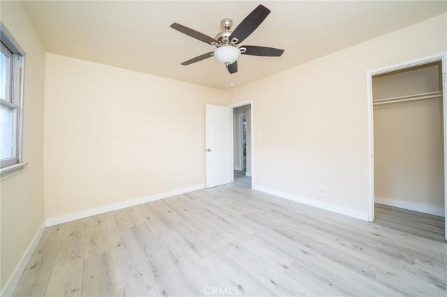 unfurnished bedroom featuring ceiling fan, light wood-type flooring, and a closet