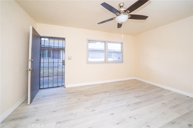 empty room featuring ceiling fan and light hardwood / wood-style floors