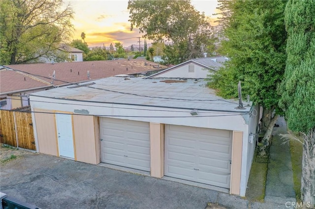 view of garage at dusk