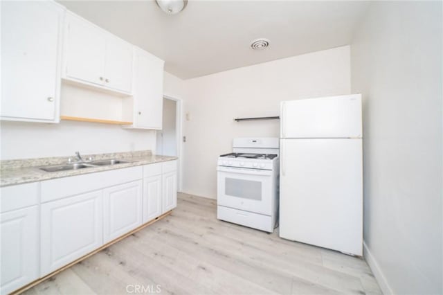 kitchen with sink, white cabinets, white appliances, and light hardwood / wood-style flooring