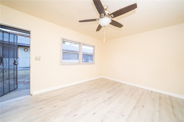 spare room featuring ceiling fan and light hardwood / wood-style flooring