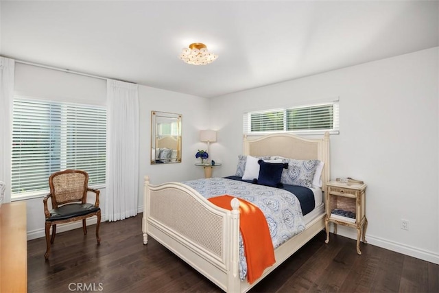 bedroom with dark wood-style flooring and baseboards