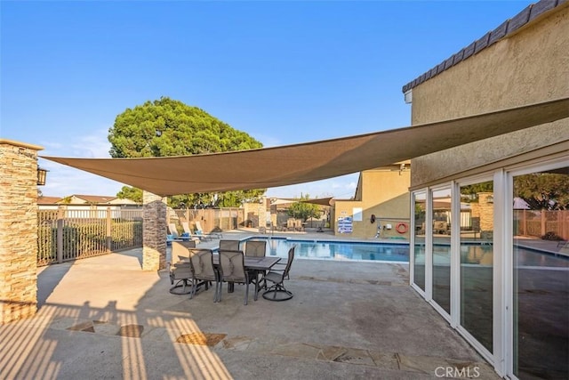 view of patio with a fenced backyard and a community pool