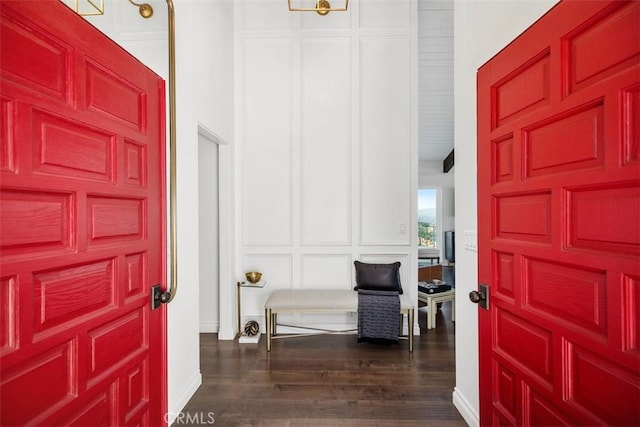 entryway featuring a decorative wall and dark wood-style flooring