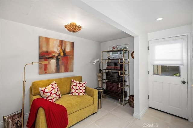 sitting room with tile patterned flooring, baseboards, and recessed lighting