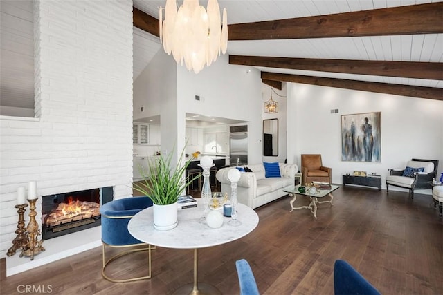 living room with high vaulted ceiling, a brick fireplace, wood finished floors, and beam ceiling