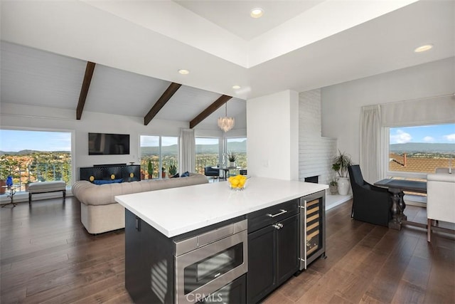 kitchen featuring open floor plan, wine cooler, dark wood-style flooring, and stainless steel microwave