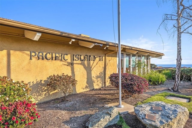 view of side of home with stucco siding