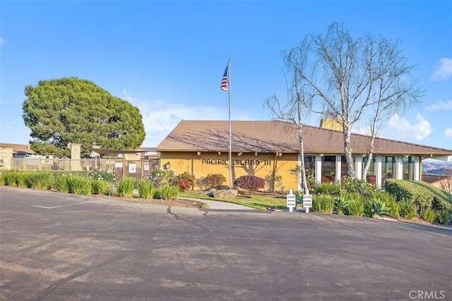 view of building exterior with fence