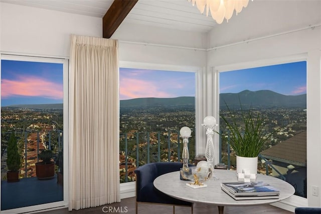 dining room with beam ceiling and a mountain view