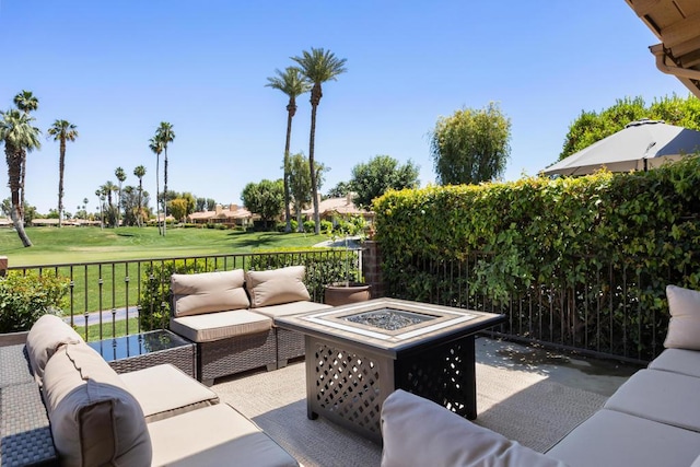 view of patio featuring an outdoor living space with a fire pit