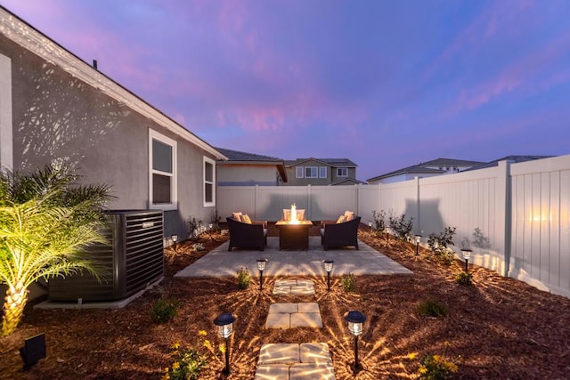 patio terrace at dusk with an outdoor fire pit and central AC