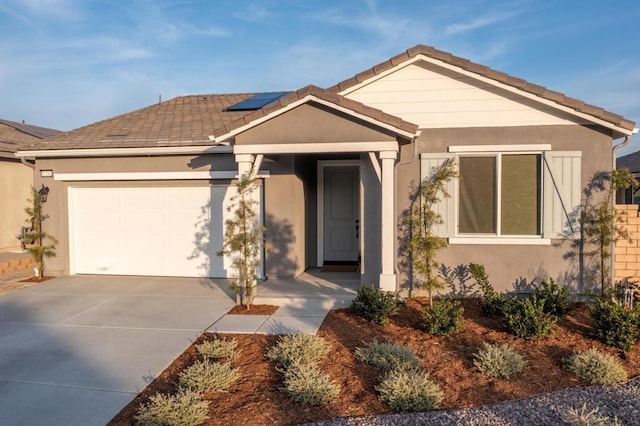 view of front facade with solar panels and a garage