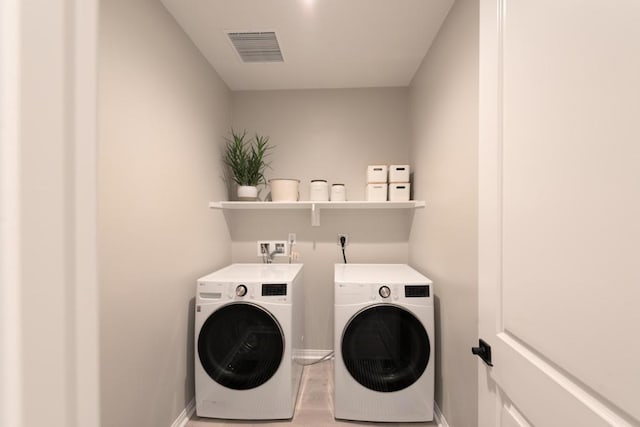 washroom featuring washing machine and dryer