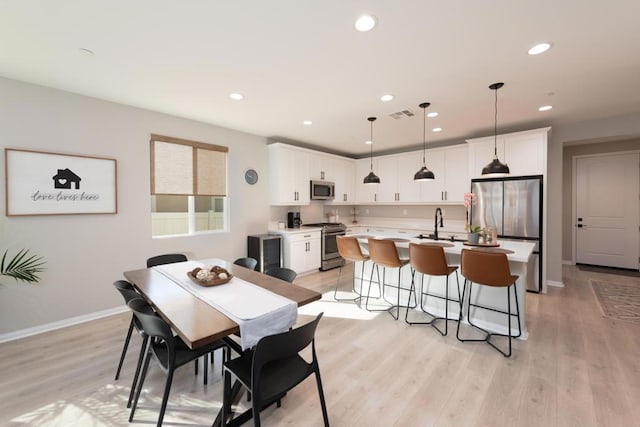 dining space featuring light hardwood / wood-style flooring