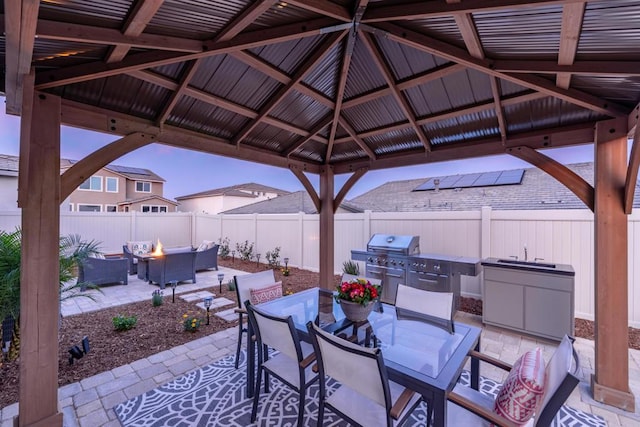 view of patio / terrace with a gazebo, a fire pit, and a grill