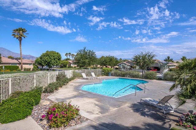 view of pool featuring a mountain view and a patio