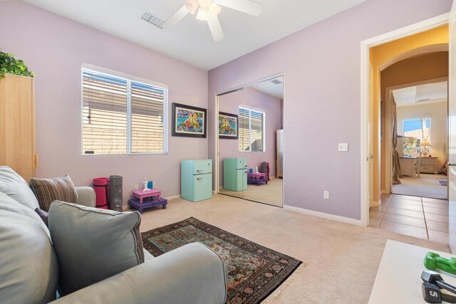 living room featuring light carpet and ceiling fan