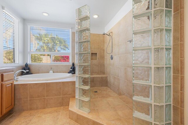 bathroom with independent shower and bath, tile patterned floors, and plenty of natural light