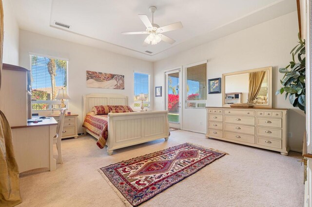 carpeted bedroom with ceiling fan and access to outside